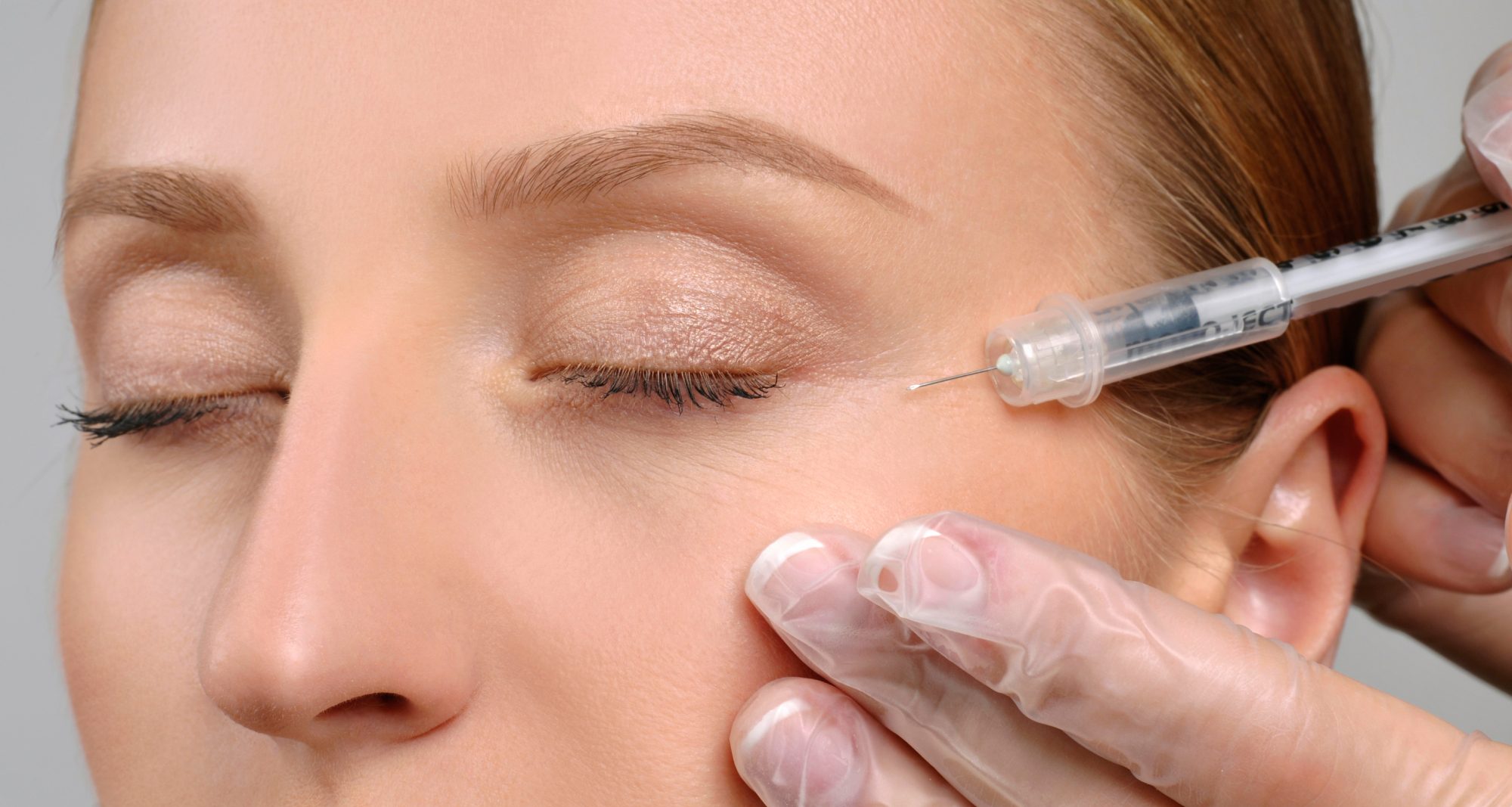 Woman is getting botox injection. Anti-aging treatment and face lift. Cosmetic Treatment. Facial skin lifting injection to woman`s face. Plastic Surgery