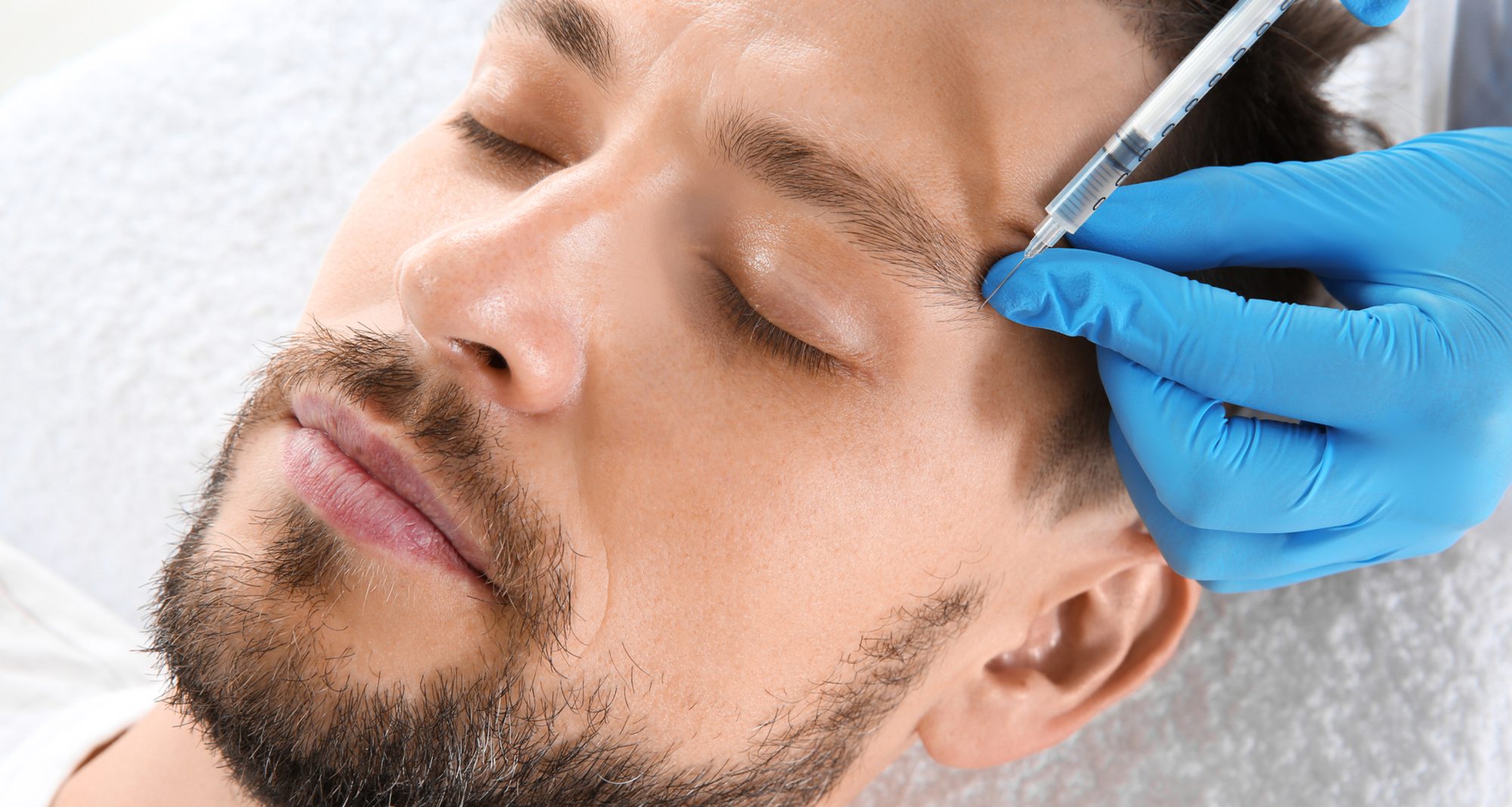 Man getting facial injection in clinic. Cosmetic surgery concept