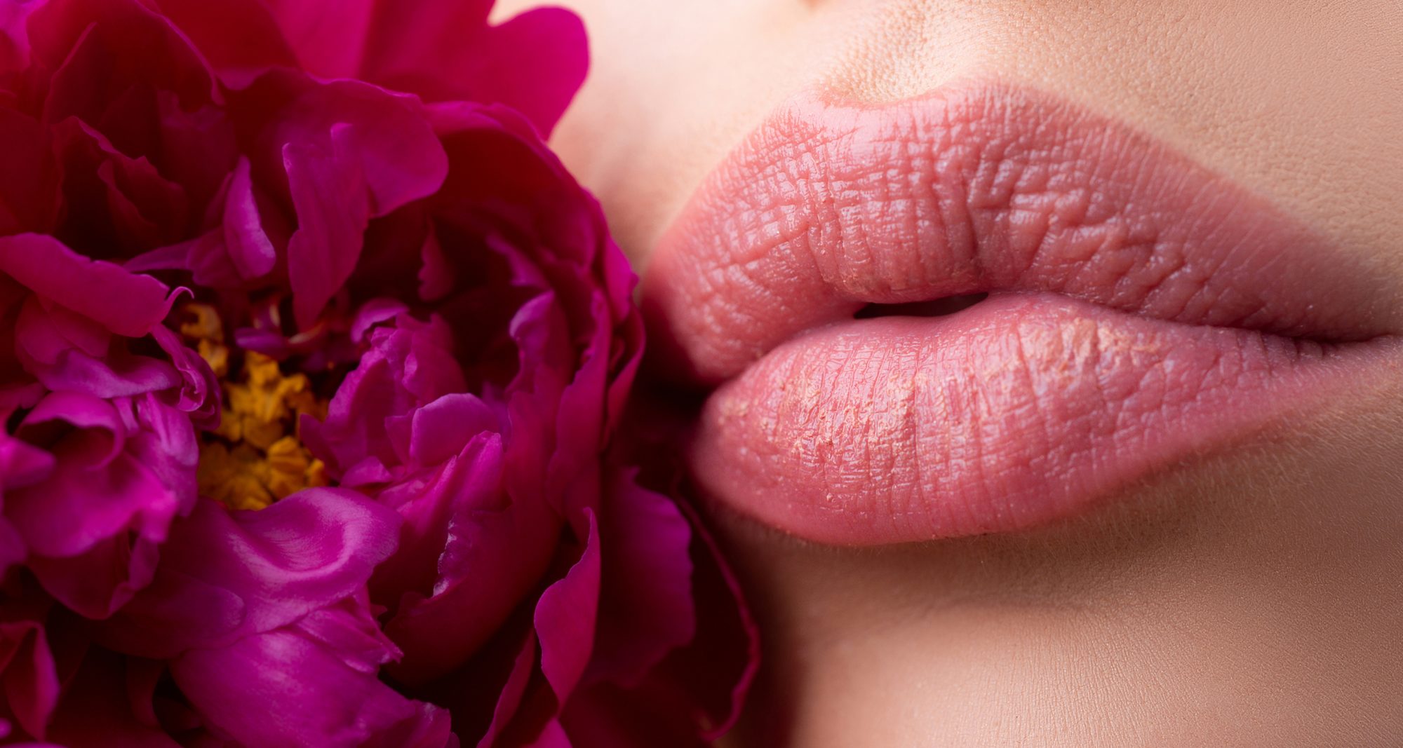 Perfect natural lip makeup. Lips with lipstick closeup. Beautiful woman lips with flowers